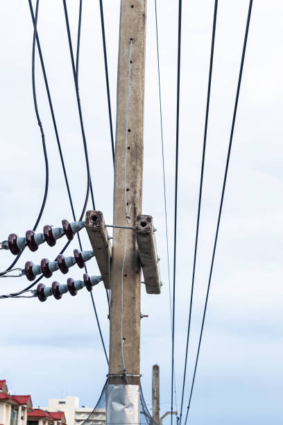 istock electric cable stretched through concrete poles against a blue sky 1197540165