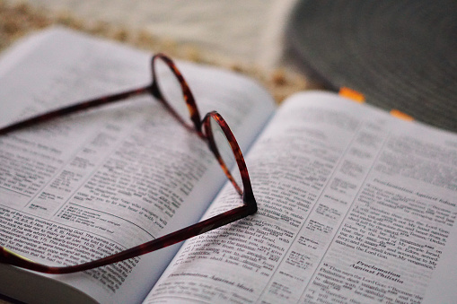 Reading glasses resting on a book