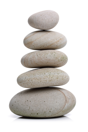 Stack of white stones balancing isolated on white