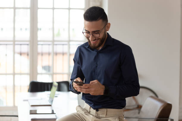 istock Millennial middle eastern ethnicity businessman using smartphone apps in office 1197547346