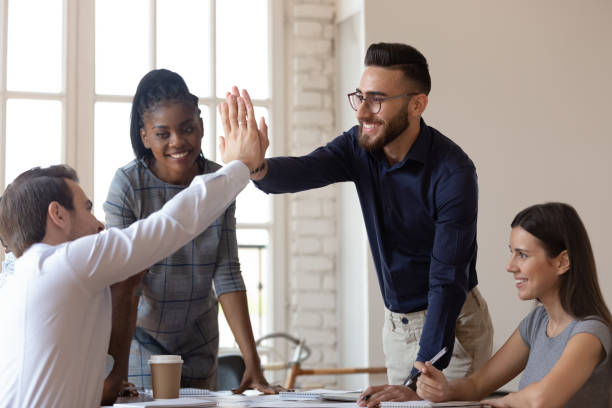 istock Multiracial businessmen giving high five during group meeting in office 1197547381