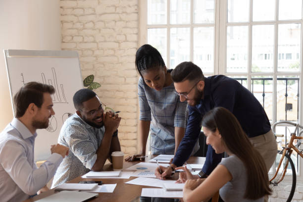 istock Arab team leader and group analyzing official papers sales results 1197547382