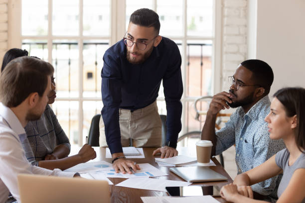 istock Middle eastern ethnicity financier presenting sales report for diverse colleagues 1197547389