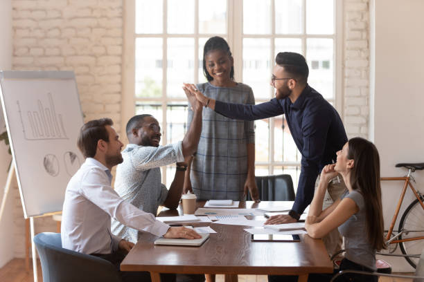istock African and arab colleagues giving high five during group meeting 1197547391