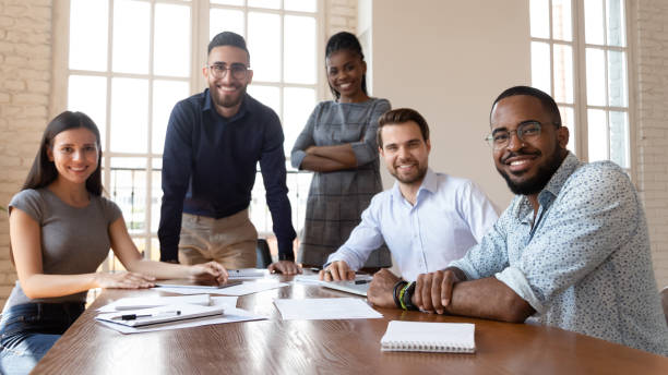 istock Happy successful multiracial team gathered together posing looking at camera 1197547398