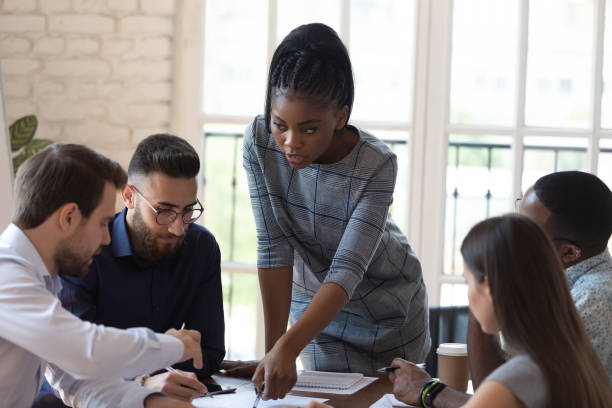 istock Multinational business group and african team leader working on project 1197547399