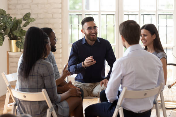 istock Diverse people sit in circle participating in team building activity 1197547434
