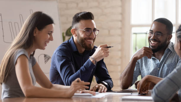 istock Middle eastern ethnicity employee and colleagues talking sitting at desk 1197547448