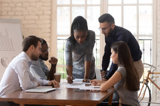 istock Diverse colleagues working on project together lead by african female 1197547559