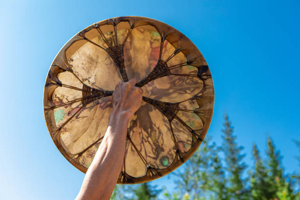 istock man holding sacred drum up in the sky 1197548369