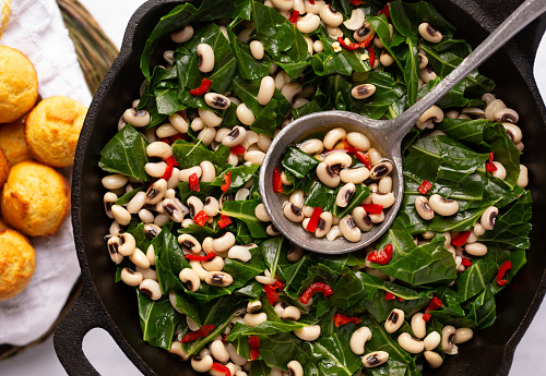 Overhead view of US southern dish of black-eye peas and collard greens