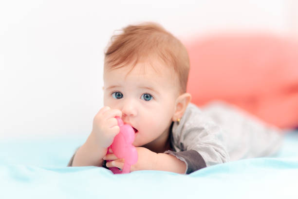 istock Cute Baby Biting on Calming Teething Toy 1197556861