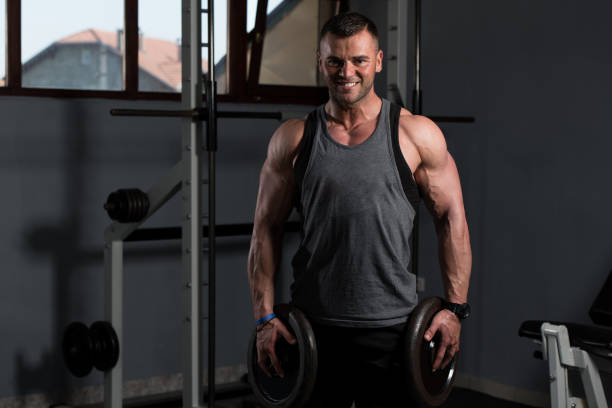 istock Fit Man Holding Weights In Hand 1197557393