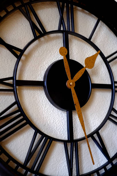 istock Clock on wall telling time reflection of passing of life 1197564015