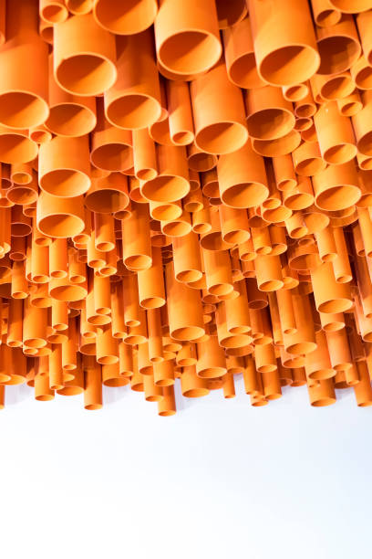 istock orange PVC pipes stacked in construction site 1197571306