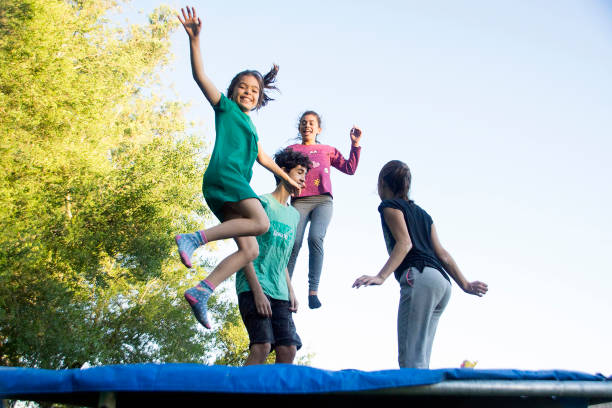 istock kids jumping on trampoline 1197572752