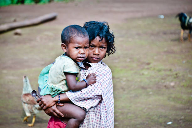 Malay, Philippines - January 11, 2016: A mother and her children, wearing school uniforms, waiting to go to school in Boracay island, on the municipality of Malay, Philippines.