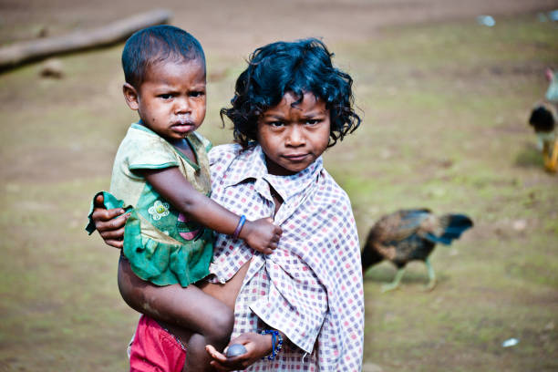Angkor, Cambodia - Nov, 2019: Two children rest in the shade in one of the windows or openings of the temple of Angkor Wat, Cambodia.