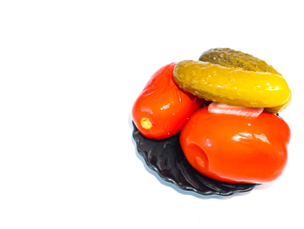 istock Canned tomatoes and cucumbers in a plate on a white background. 1197575654