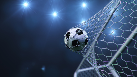 Soccer ball flew into the goal. Soccer ball bends the net, against the background of flashes of light. Soccer ball in goal net on blue background. A moment of delight, 3D illustration