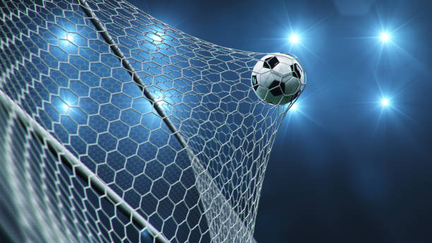 Soccer ball flew into the goal. Soccer ball bends the net, against the background of flashes of light. Soccer ball in goal net on blue background. A moment of delight. 3D illustration Soccer ball flew into the goal. Soccer ball bends the net, against the background of flashes of light. Soccer ball in goal net on blue background. A moment of delight, 3D illustration football pitch stock pictures, royalty-free photos & images