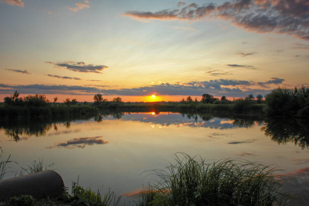 istock Sunset or sunrise on the cloudy sky on lake 1197586566