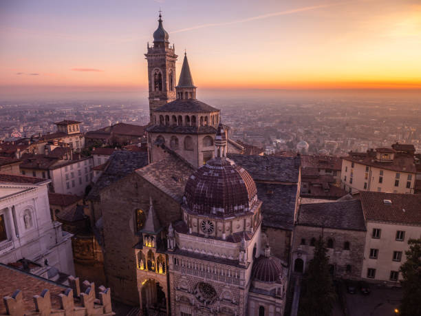 Bergamo, Italy. The old town. Amazing aerial view of the Basilica of Santa Maria Maggiore and the chapel Colleoni. Landscape of the city center and Its landmarks during a wonderful sunset stock photo
