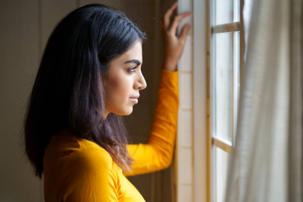 istock Persian woman while looking through the window 1197593662