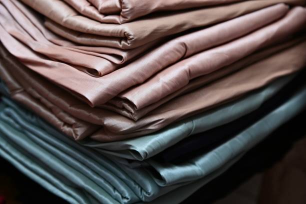 istock Taffeta fabric is a crisp, smooth, plain woven textile made from silk or cuprammonium rayons as well as acetate and polyester. 1197602359