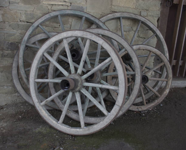 istock Old wooden wheels - carriage leaning against wall 1197603710