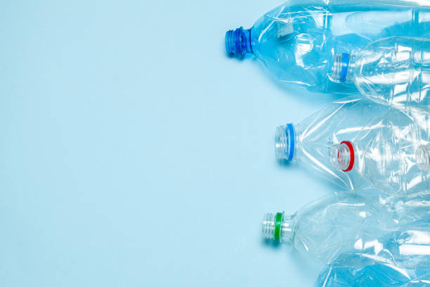 istock Crumpled plastic bottles on a blue background. Plastic trash. Copy space for text. 1197606097