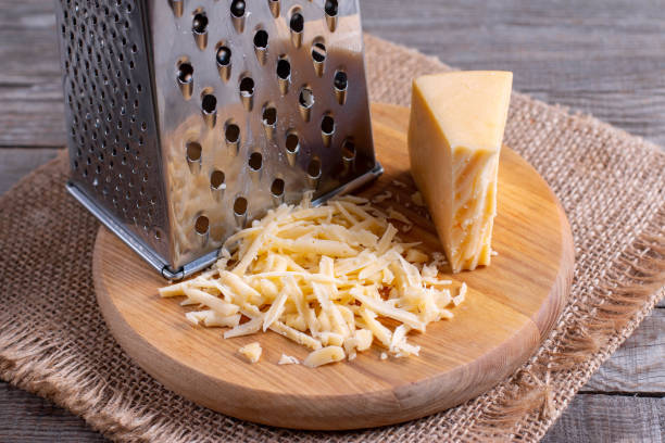 istock Grated cheese on a cutting board on a wooden table 1197606111