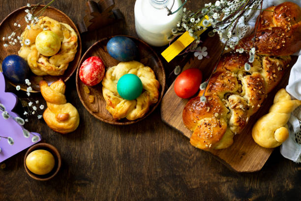 istock Easter holiday table. Easter cakes and colored eggs on a wooden table. Top view flat lay background. Copy space. 1197613231