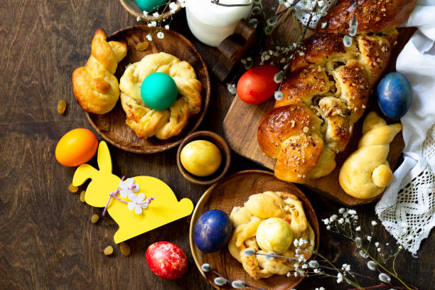 istock Easter holiday table. Easter cakes and colored eggs on a wooden table. Top view flat lay background. 1197613233