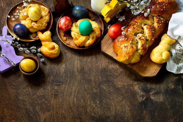istock Easter holiday table. Easter cakes and colored eggs on a wooden table. Top view flat lay background. Copy space. 1197613234