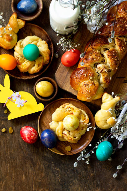 istock Easter holiday table. Easter cakes and colored eggs on a wooden table. Top view flat lay background. Copy space. 1197613235