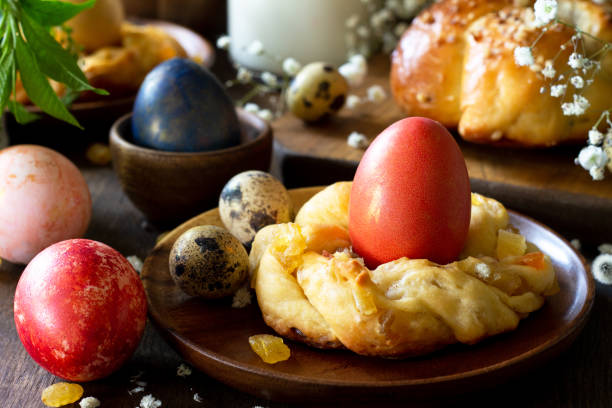 istock Easter holiday table. Easter cakes and colored eggs close-up on a wooden table. 1197613253