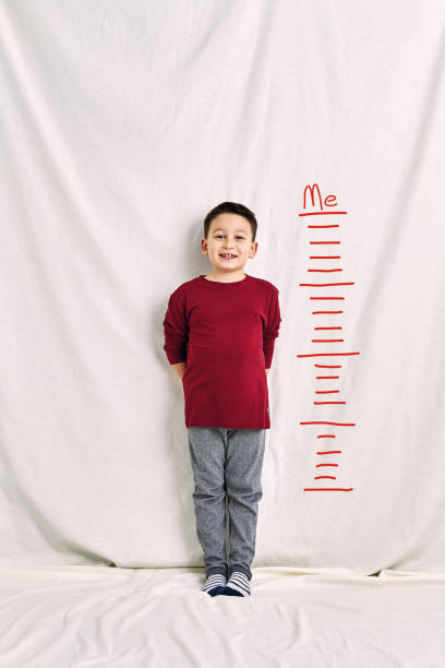 istock Cute child measuring his height. Growth concept. 1197613578
