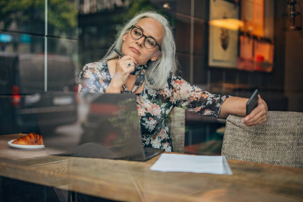 istock Mature woman sitting in cafe alone 1197613596