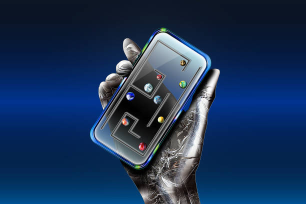 istock A metallic robot is holding an smartphone and playing an analog game. 1197613632