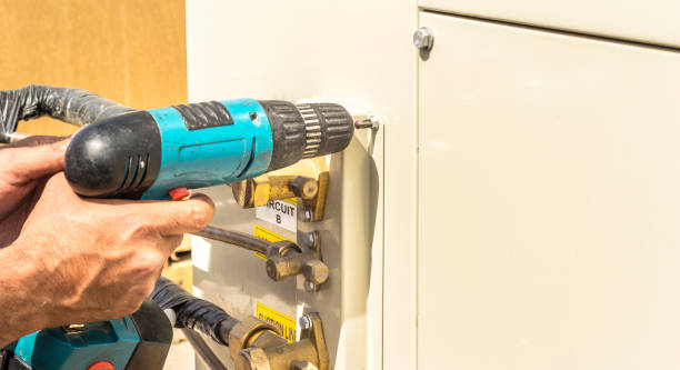 istock a professional electrician is working on a heavy duty central air conditioning system by a drill machine 1197619370
