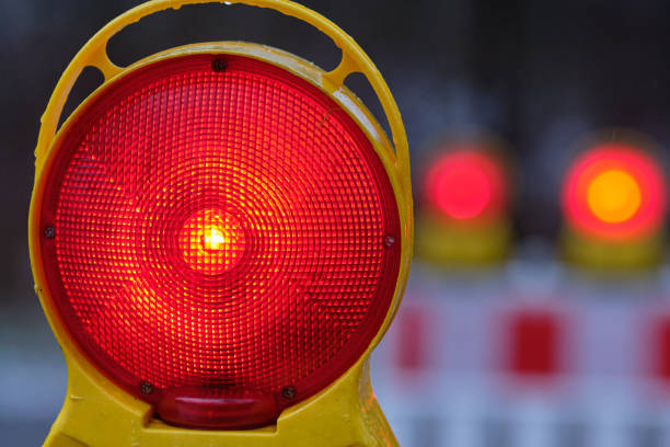 istock Closeup of red warning light glowing in the dark 1197620566