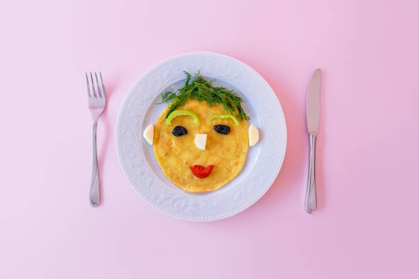 Funny prepared omelette with human face shape for kids.