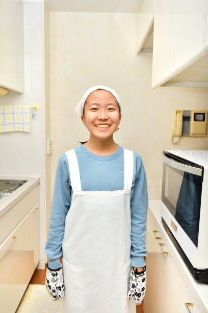 istock Japanese girl smiling in the kitchen 1197622000