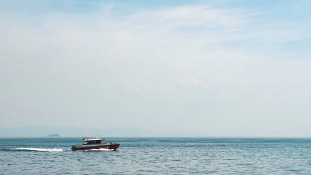 istock boat sails in sea leaving trace against disappearing ship 1197622154