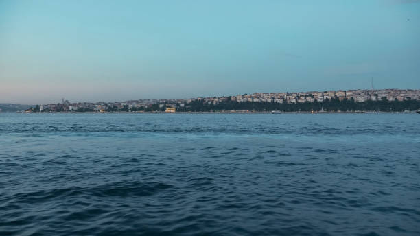 istock deep blue sea waves against city in dusk view from ship 1197622214