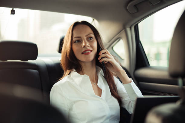 istock Beautiful lady talking on mobile in car 1197626601