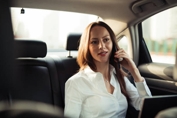 istock Beautiful lady talking on mobile in car 1197626639