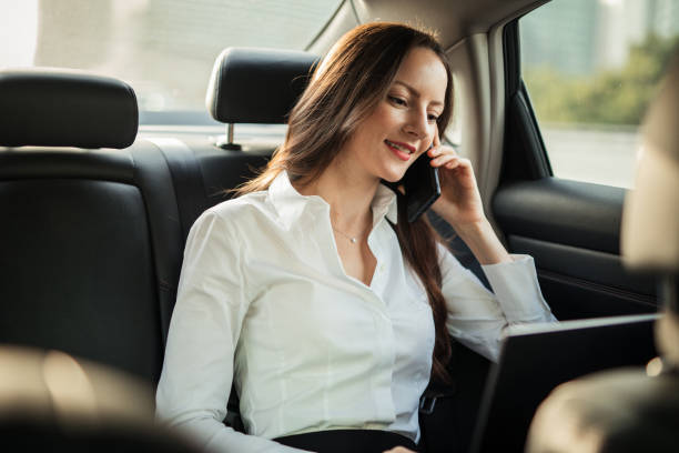 istock Beautiful lady talking on mobile in car 1197626657