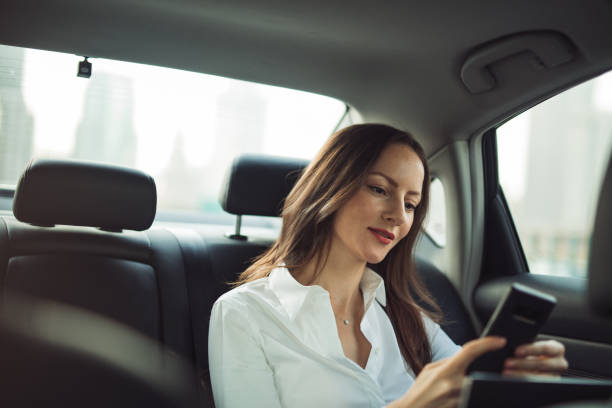 istock Business woman using mobile in car 1197626715